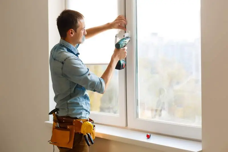 Man Worker Mounting Window On Balcony