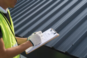 Worker Inspector Engineer Is Check And Inspect Roof House Or Building Quality After Roofing Repair Replace With Check List In Hand Inspect And Checking Concept